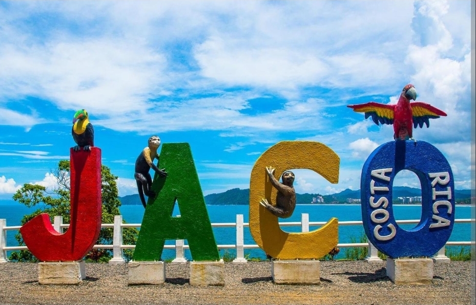 Colorful Jacó Costa Rica sign with wildlife sculptures